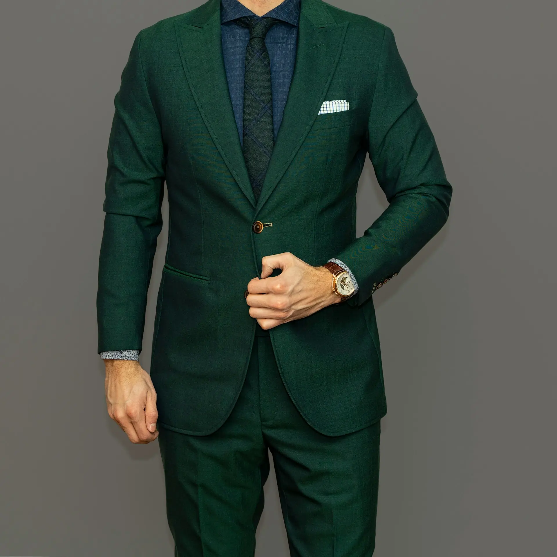 man in blue suit jacket and black pants